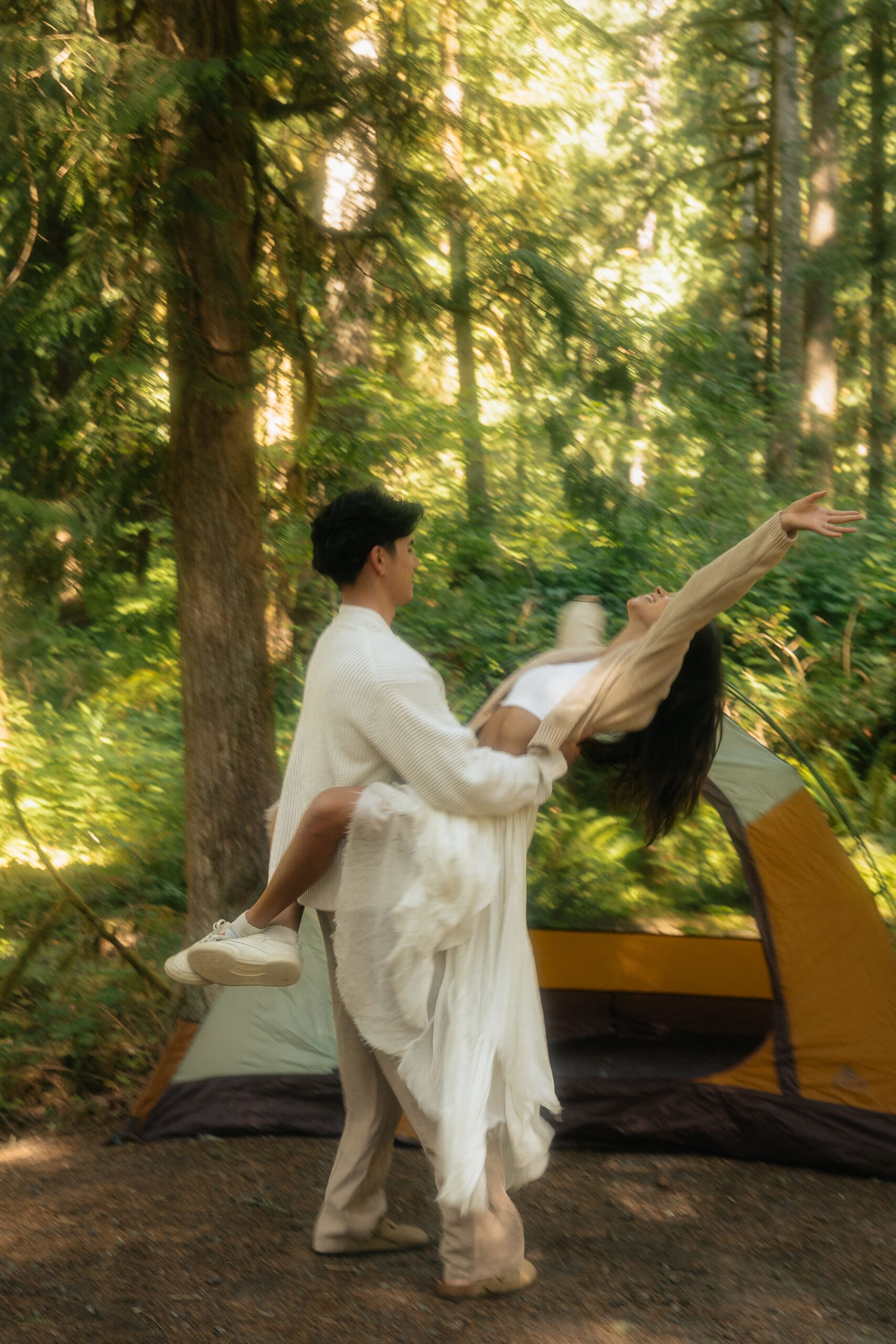 couple dancing near their camping set up